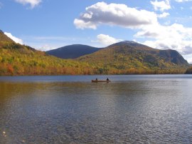 lake-with-canoe-and-mountains-in-fall